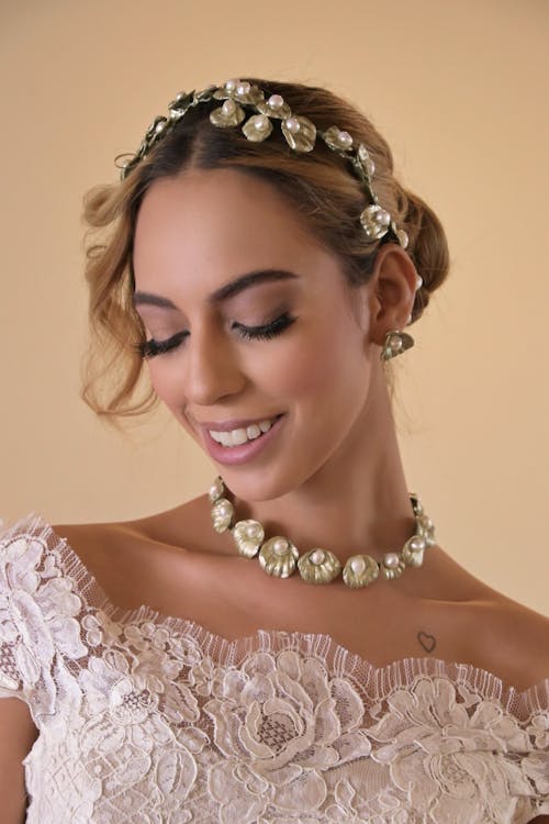 Woman in White Top Wearing Makeup and Hair Accessory