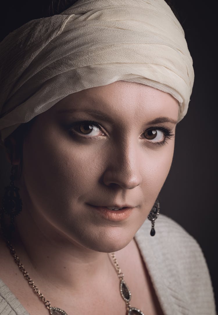 Portrait Of A Woman In A White Headscarf And Long Earrings