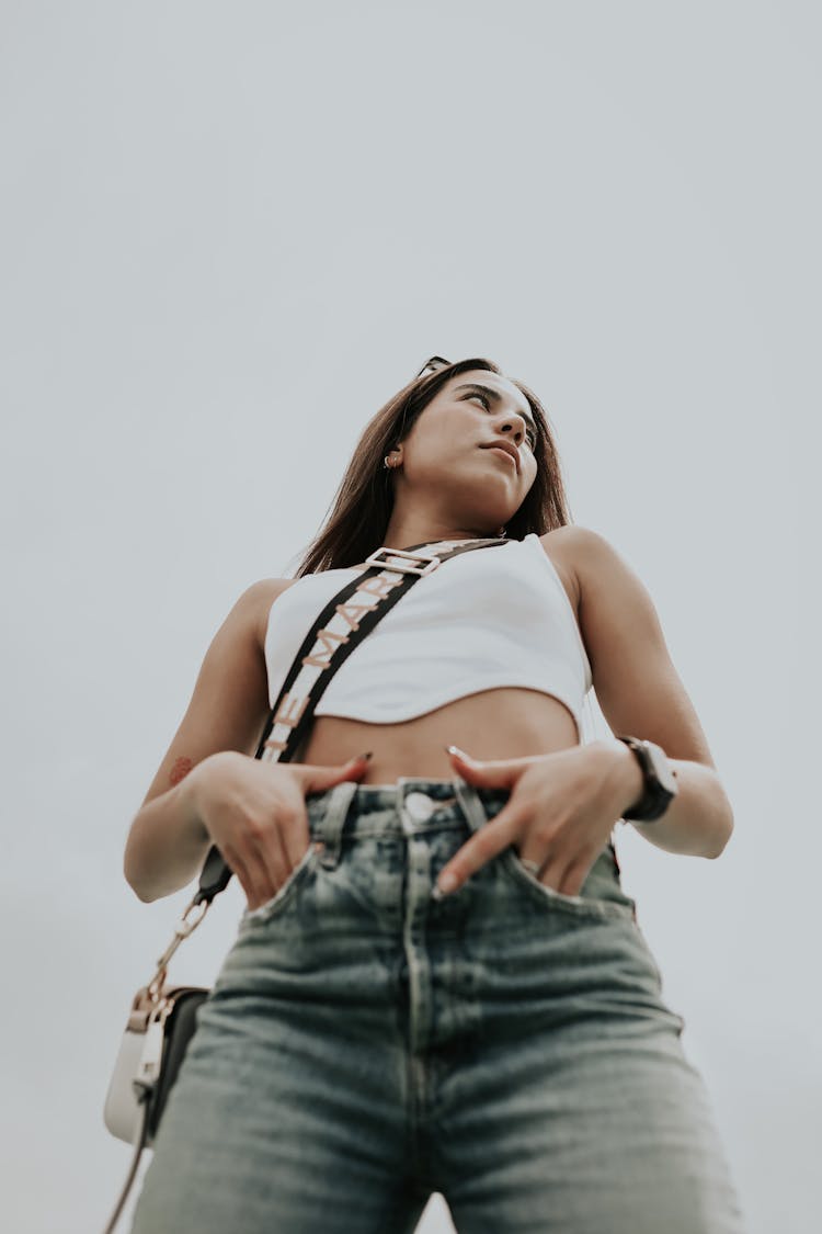 Girl In Jeans On Sky Background