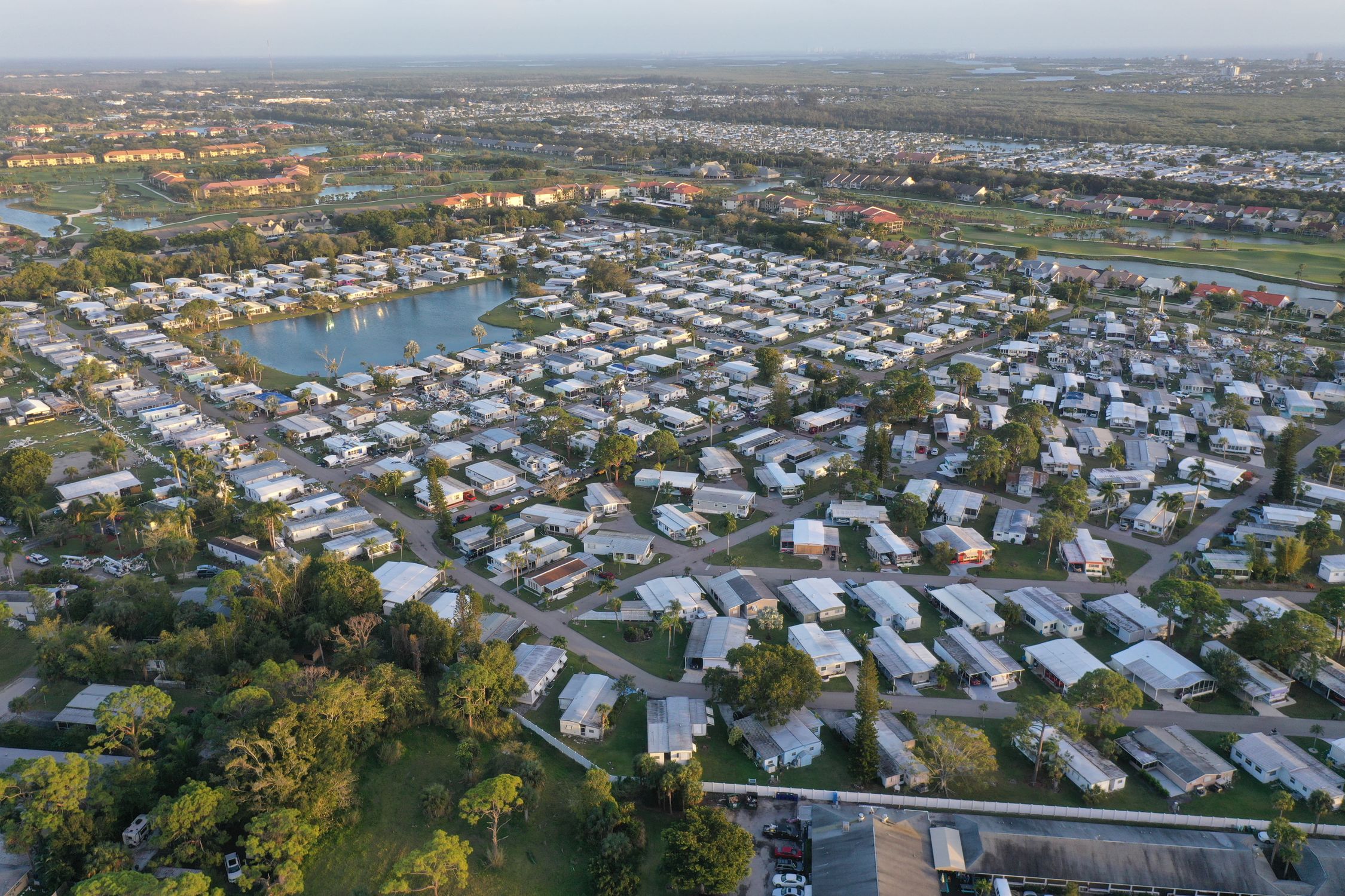 Aerial view of a sprawling Florida residential neighborhood with curving streets and rooftops, representing the new home construction rising near Orlando's growing Epic Universe theme park corridor
