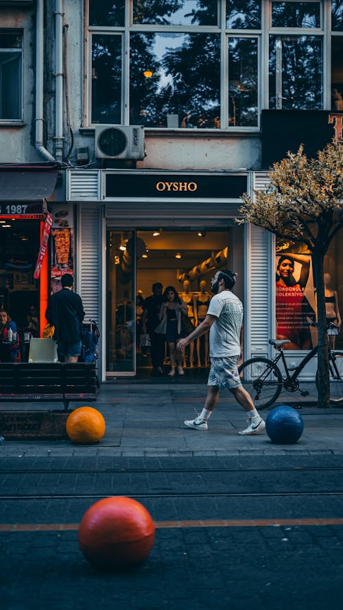 People Walking Out of a Clothing Store in City 