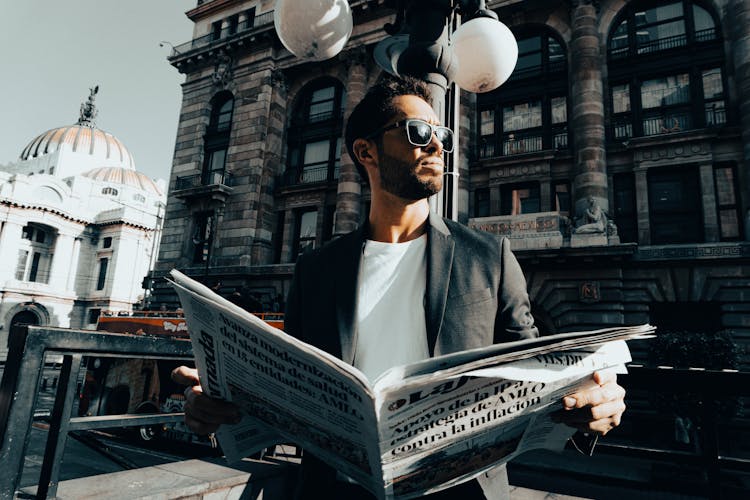 Bearded Man Holding Newspaper