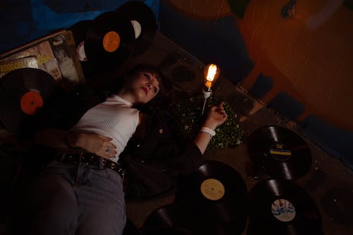 Woman Lying among Vinyl Records