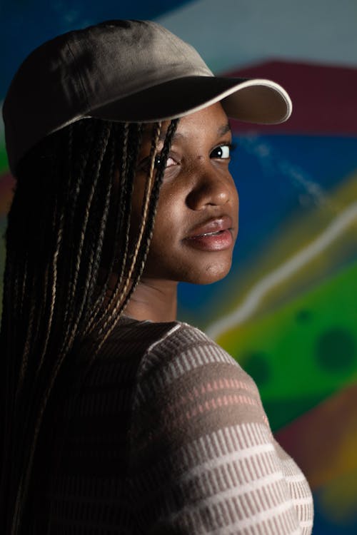 Free A Woman With Braids Looking Over Her Shoulder  Stock Photo