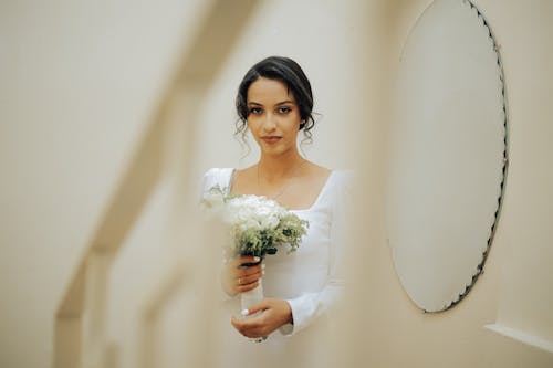 A Bride Holding a Bouquet of Flowers 