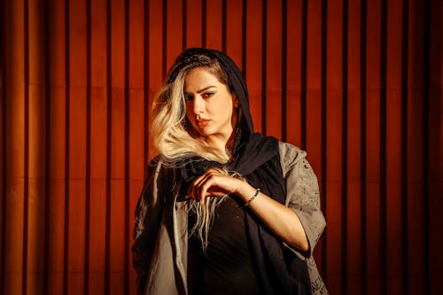 Studio Shot of a Young Woman Wearing a Jacket and Scarf 