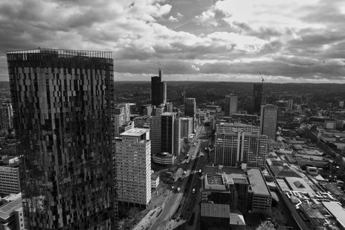 Free Black and white aerial view of London's modern architecture and skyscrapers under dramatic clouds. Stock Photo