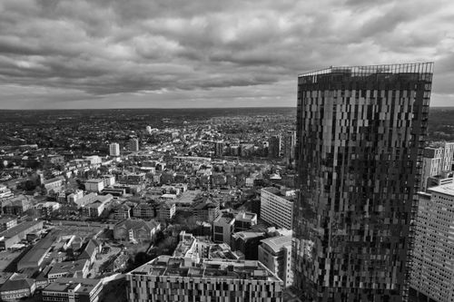 Free Black and white aerial view capturing London's modern skyscraper and urban landscape under cloudy skies. Stock Photo