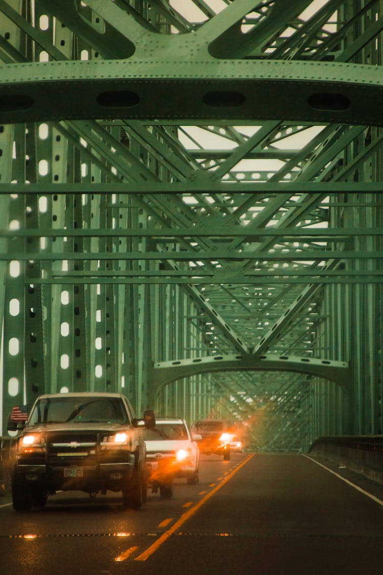 Cars With Lights Driving On Suspension Bridge