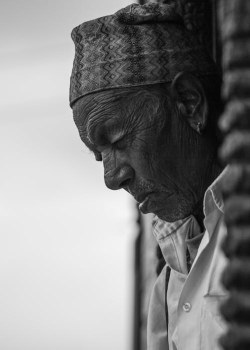 Grayscale Photo of a Man With Headdress