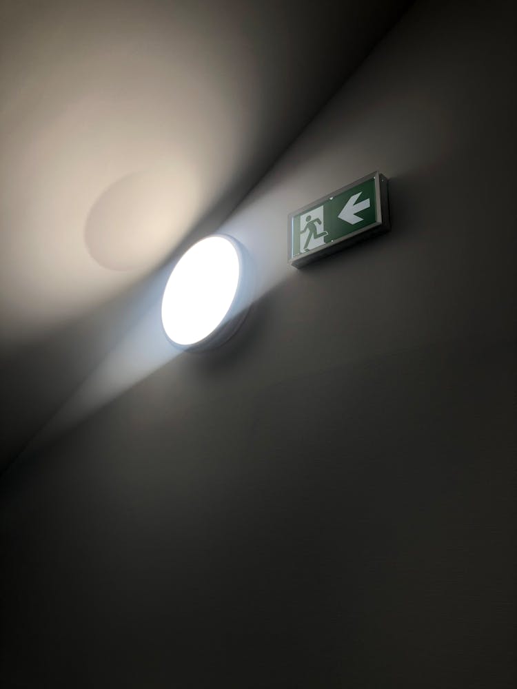 A Light Near A Fire Exit Signage