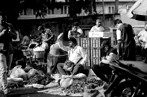 Free Vibrant street market in Surat, India showcasing local vendors in a candid black and white shot. Stock Photo