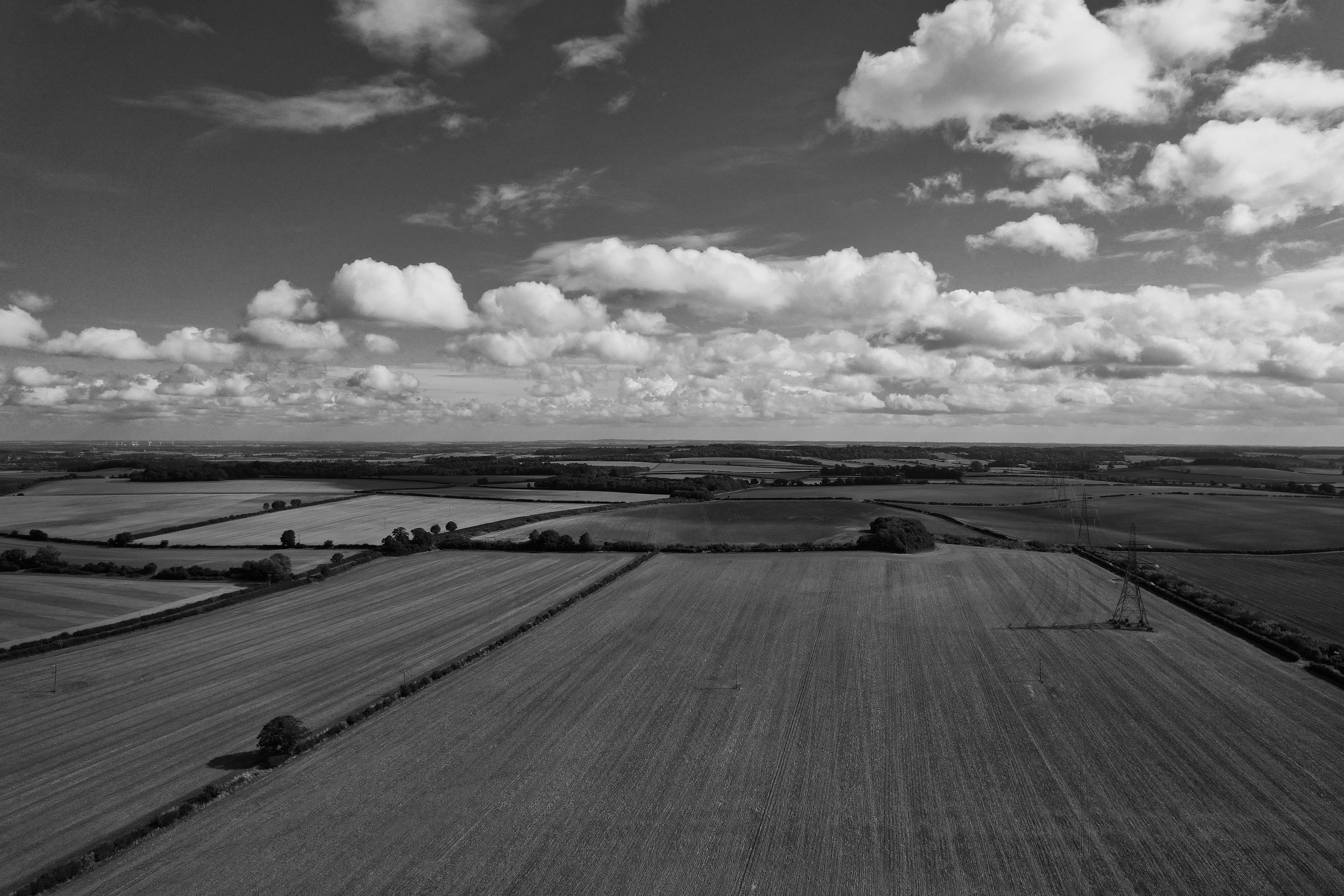 grayscale drone shot of a countryside in england