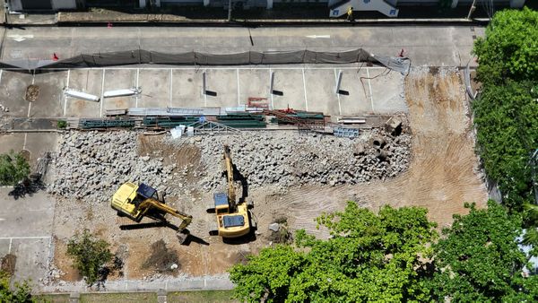 Surveyor RTK mapping a construction site with excavators