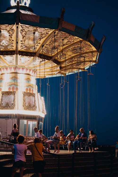 Free People Standing on White and Gold Carousel Stock Photo