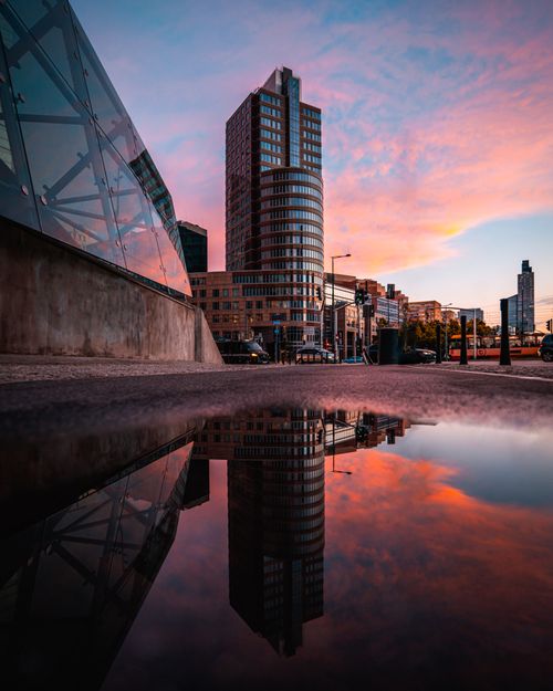 Free Captivating Warsaw cityscape with building reflections in a puddle at dusk. Stock Photo