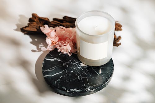 Free Candle and Flowers on Plate Stock Photo