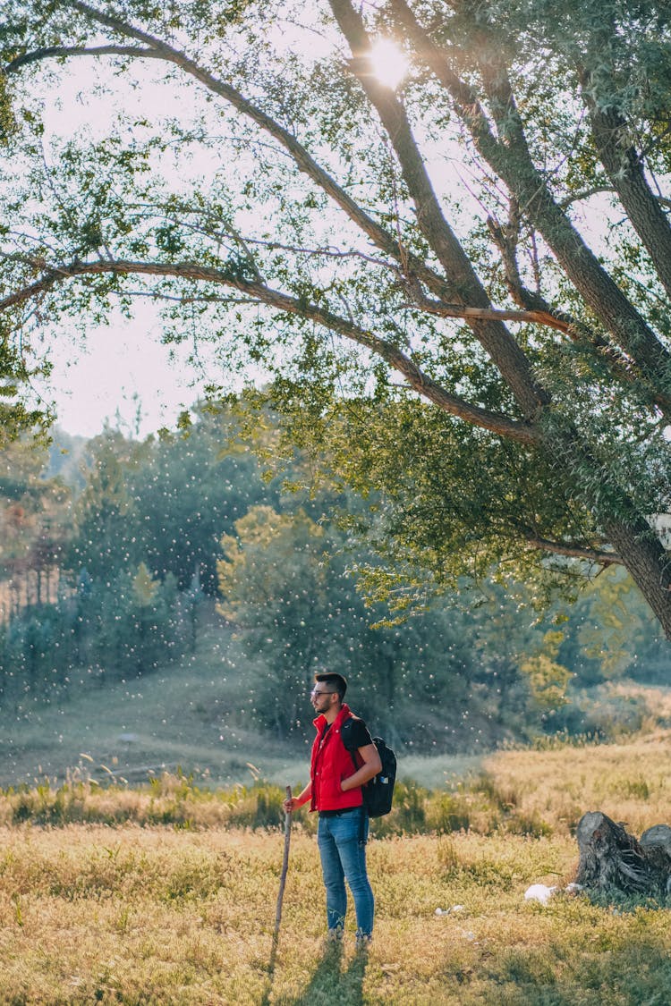 A Man In Red Vest In A Hiking Trip