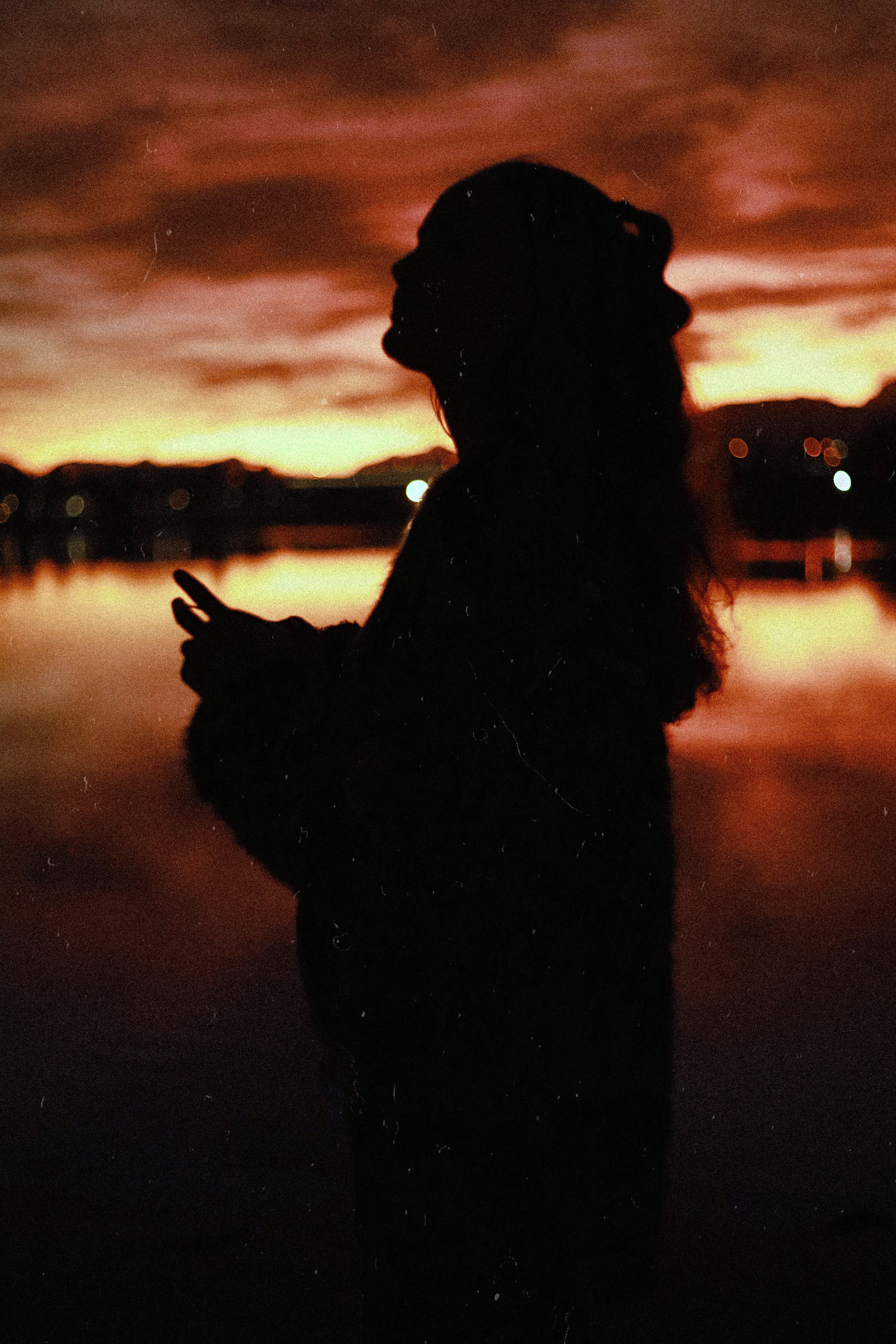 Silhouette of a Girl at Sunset · Free Stock Photo