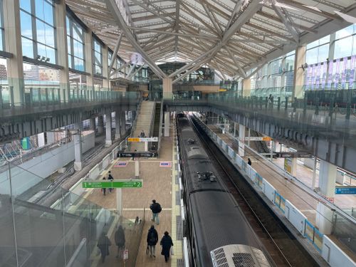 Free High angle view of a bustling railway station in Tokyo with commuters and trains. Stock Photo