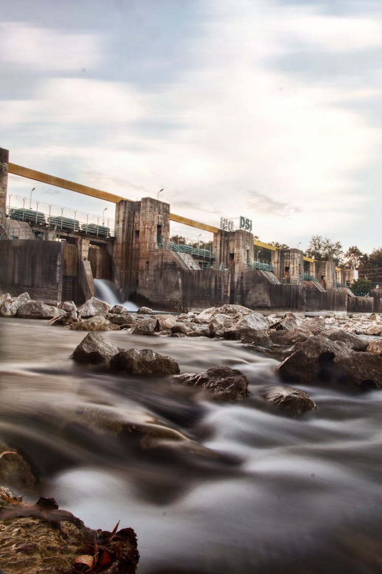 Flowing Water Over Stones Behind Dam