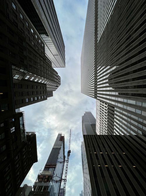 Free A striking upward view of New York City skyscrapers against a cloudy sky. Stock Photo
