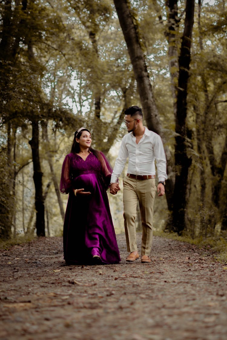 A Couple Walking In The Forest Trail