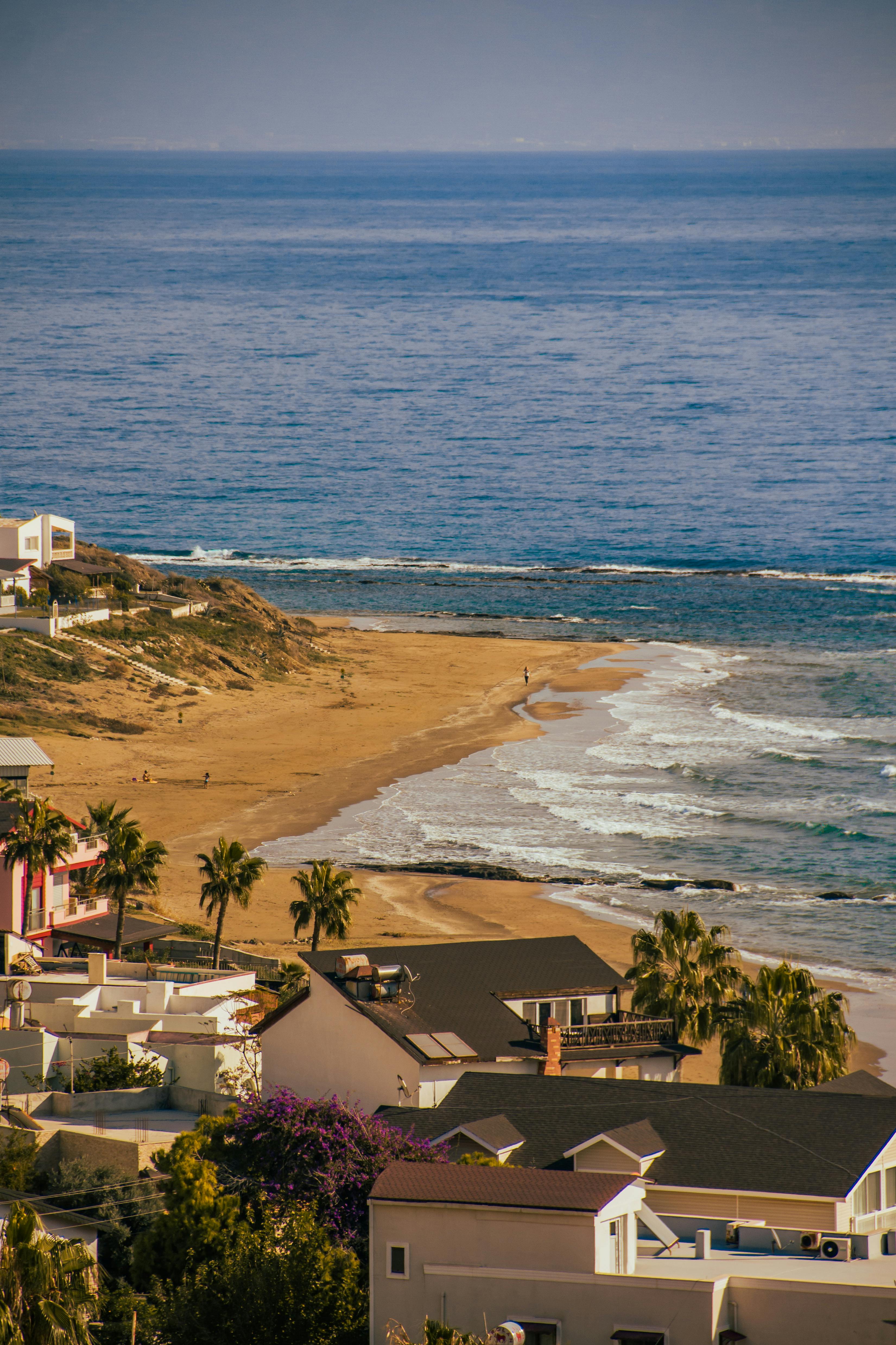 photo of a seascape with houses on the beach