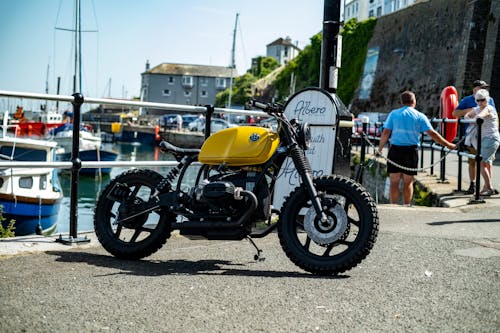 A Yellow BMW Motorcycle by the Seaside