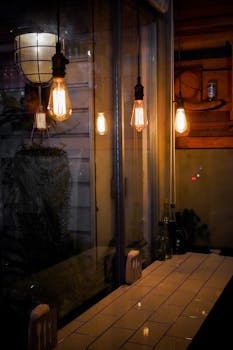 Warm and inviting cafe interior with elegant Edison bulb lighting creating a cozy atmosphere.