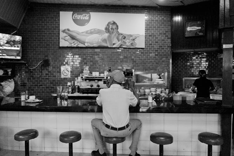 Back Of A Man Sitting At The Bar