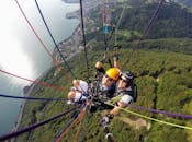 People Riding Cable Cars over Green Mountain