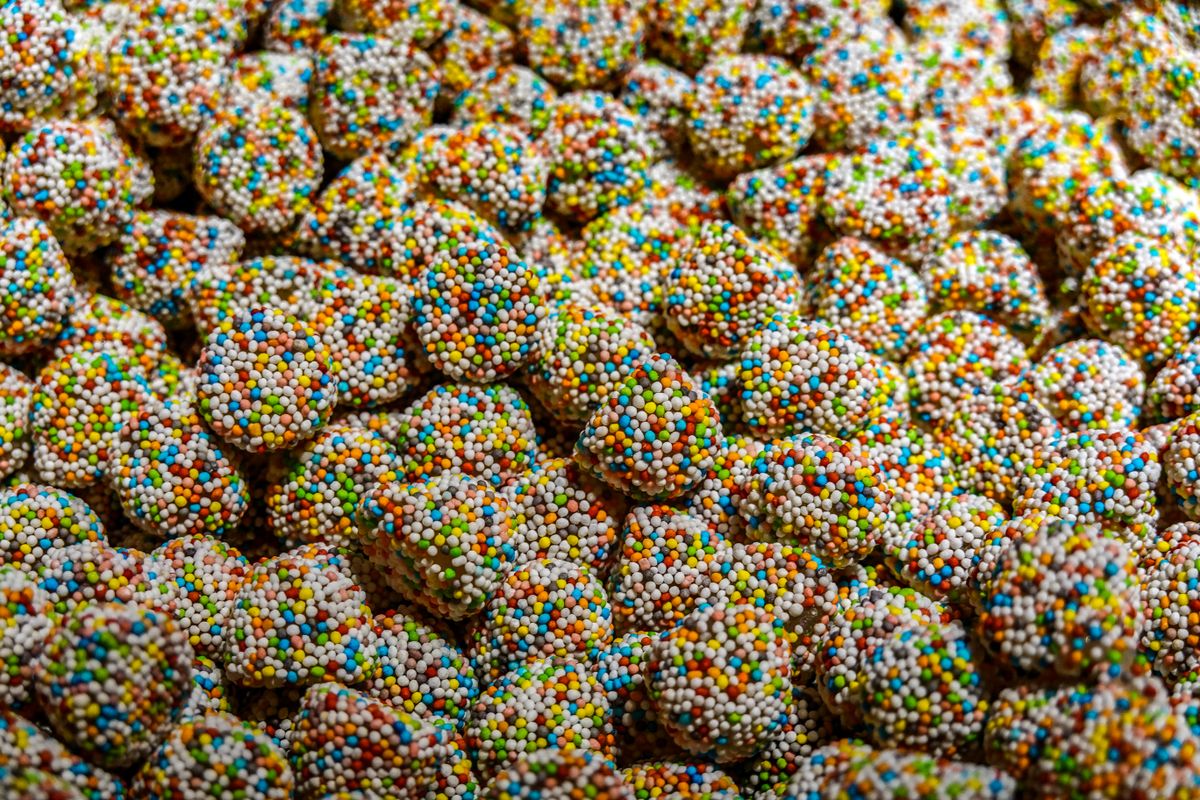 A vibrant close-up of assorted candies covered in multicolored sugar sprinkles.