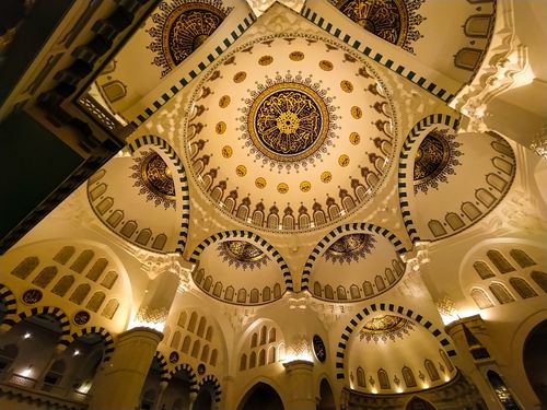 Free Stunning low angle shot of an ornate mosque ceiling with intricate golden and navy designs. Stock Photo