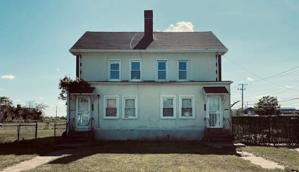 Classic two-story house with vintage exterior design under a clear blue sky.