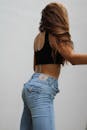 A Woman in Black Tank Top and Denim Jeans