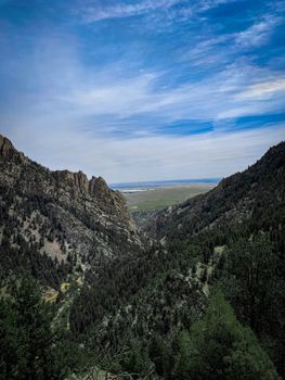 A stunning aerial view of a rocky mountain pass under a blue sky, capturing the essence of nature's beauty.