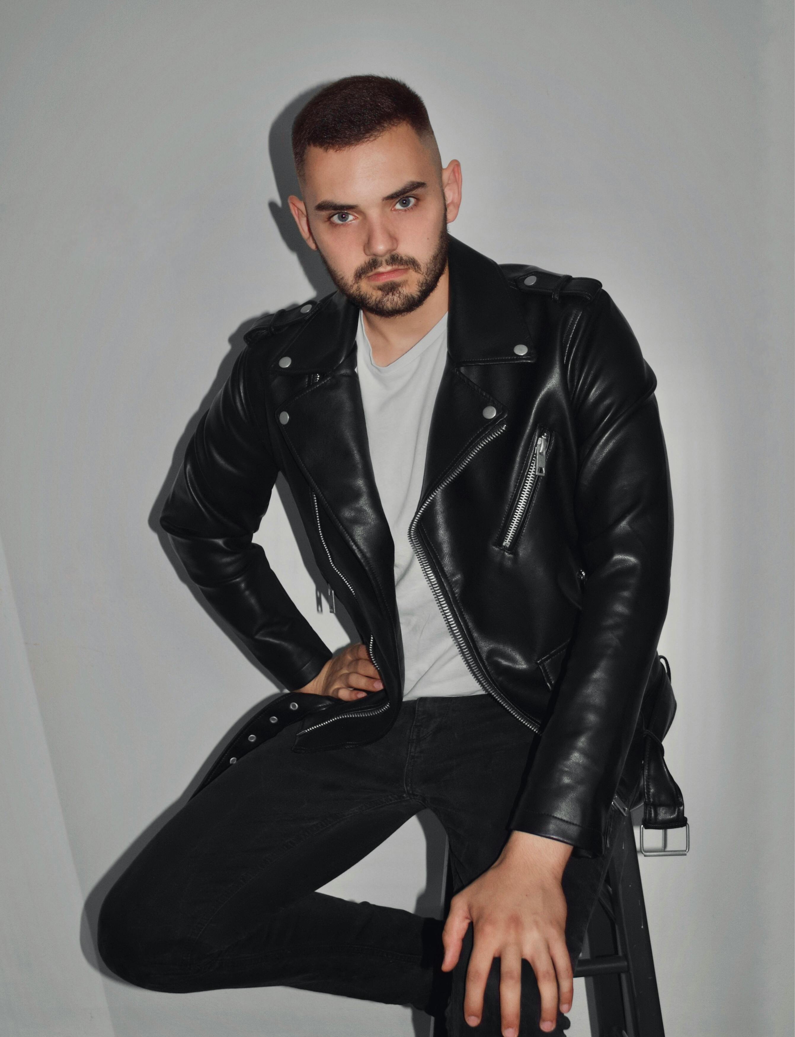 Woman In Leather Jacket and Pants Sitting on Stool · Free Stock Photo