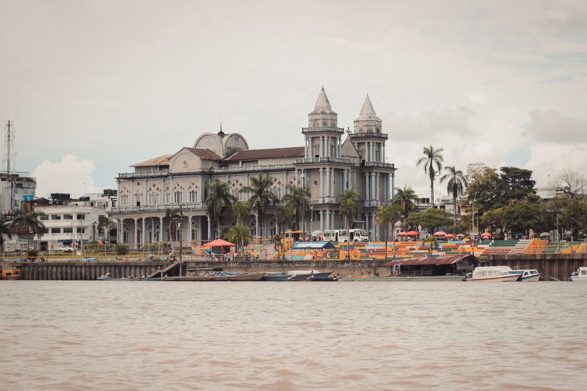 A picturesque view of a historic cathedral along the riverfront in Quibdó, showcasing stunning architecture.