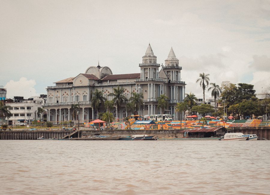 A picturesque view of a historic cathedral along the riverfront in Quibdó, showcasing stunning architecture.