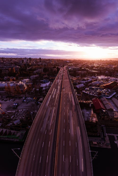 Free stock photo of drone picture above bridge during traffic hours during sunset Stock Photo