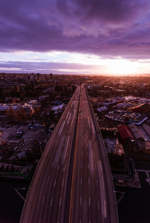 Free A breathtaking aerial view of Vancouver, showcasing the city's roads and skyline during sunset. Stock Photo