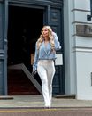 Woman with Blonde Hair Walking and Looking Around