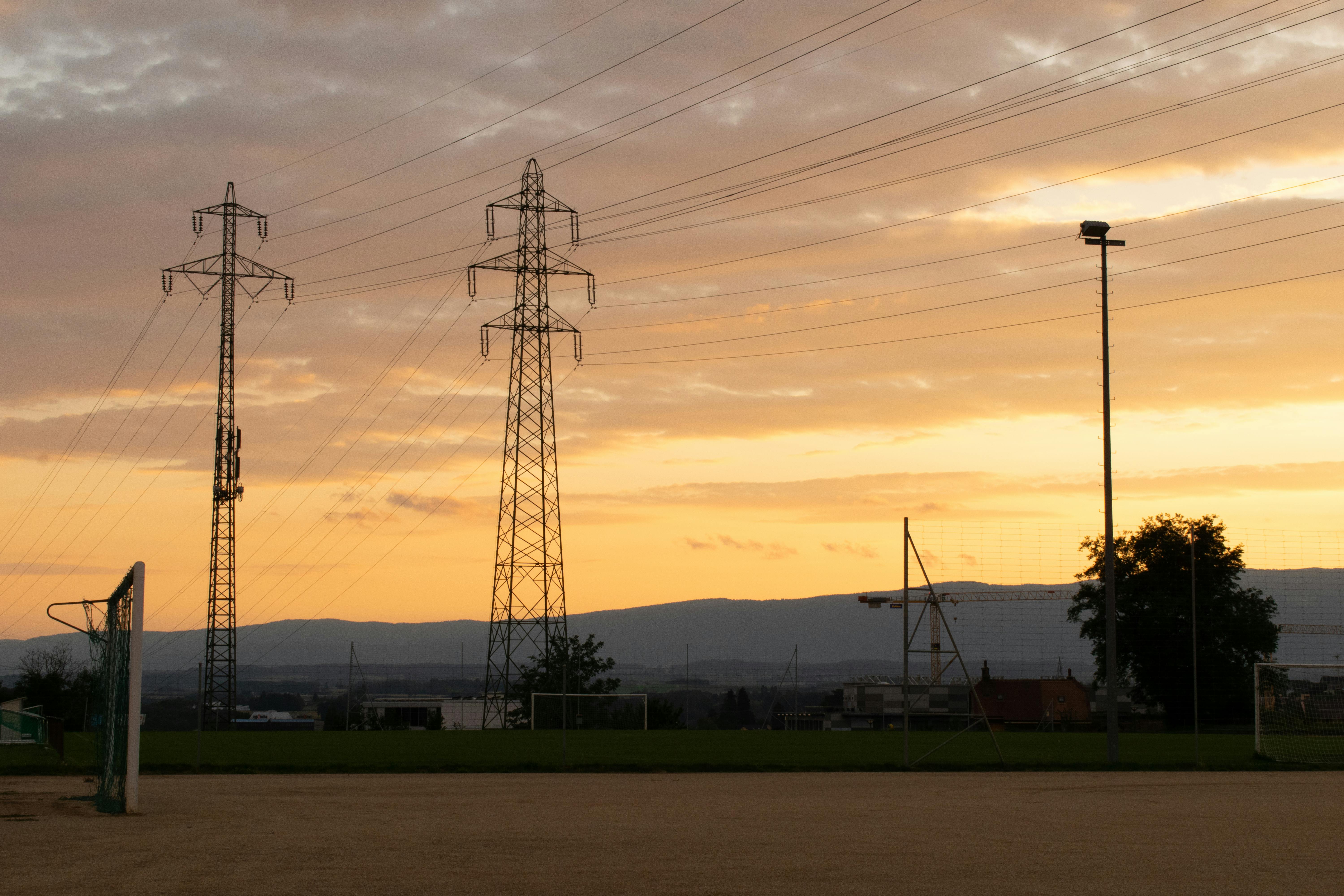 Free stock photo of electric lines, football field, golden sunset