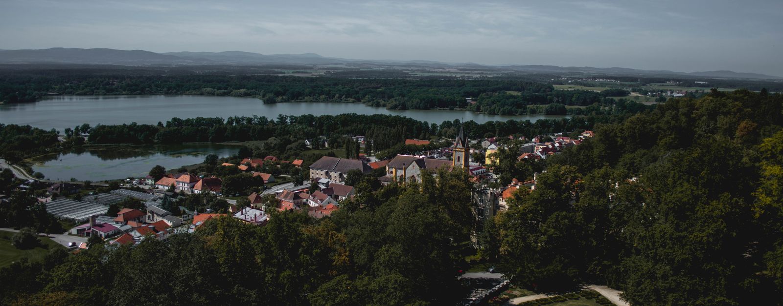 Breathtaking aerial view of České Budějovice with lush greenery and serene water bodies.