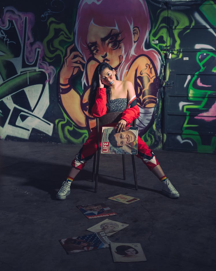 A Woman Posing In Front Of A Mural