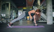 Woman in Black Sports Bra and Gray Leggings Doing Exercise