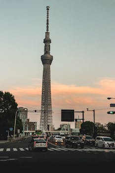 Scenic view of Tokyo Skytree at dusk with busy city traffic, capturing urban life.