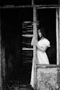 Woman in White Dress Standing on Window