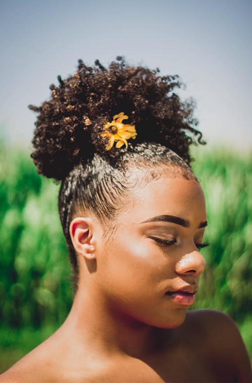 Woman With Yellow Flower on Her Hair 